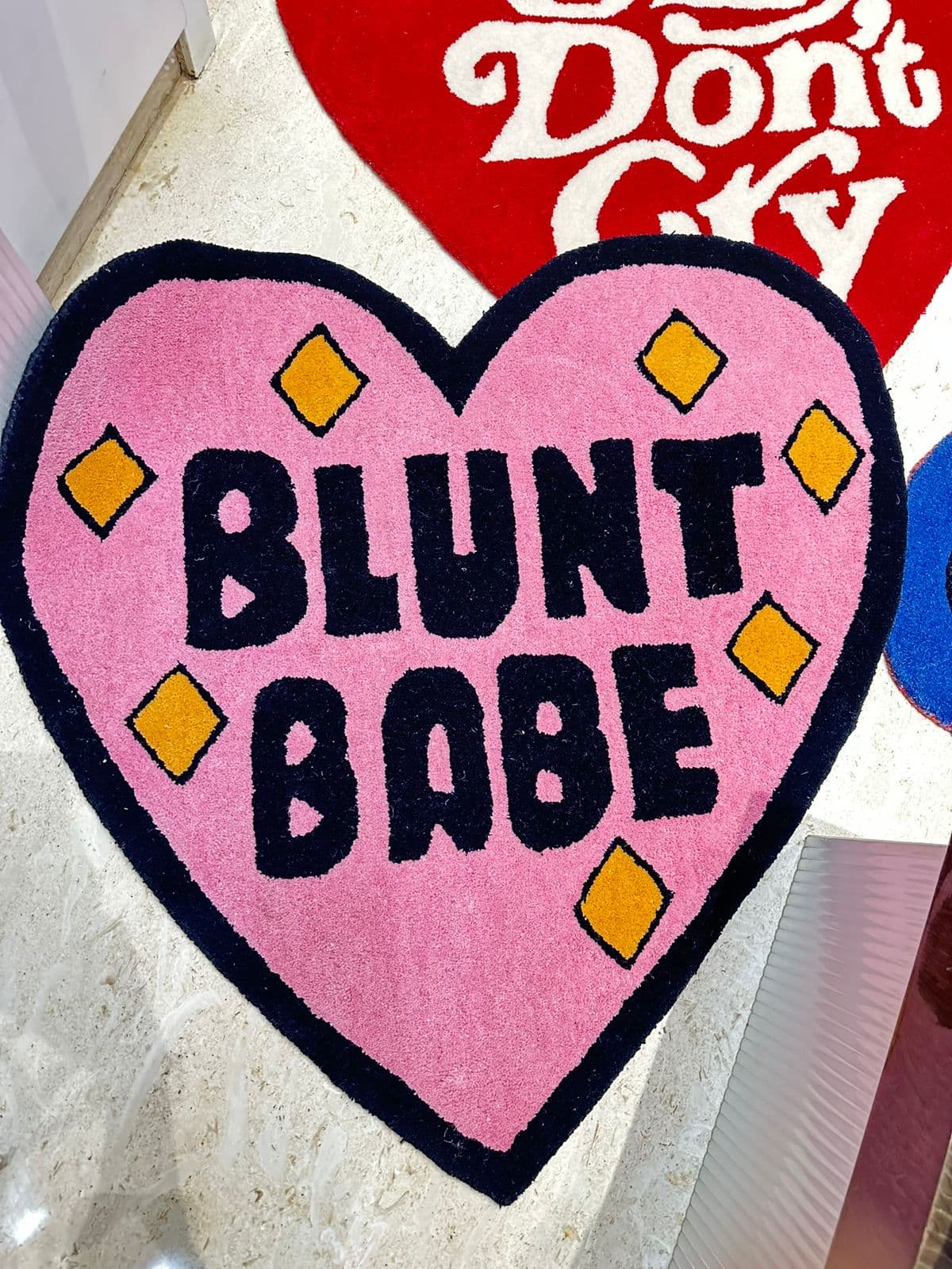 Blunt Babe heart-shaped tufted rug in pink and black