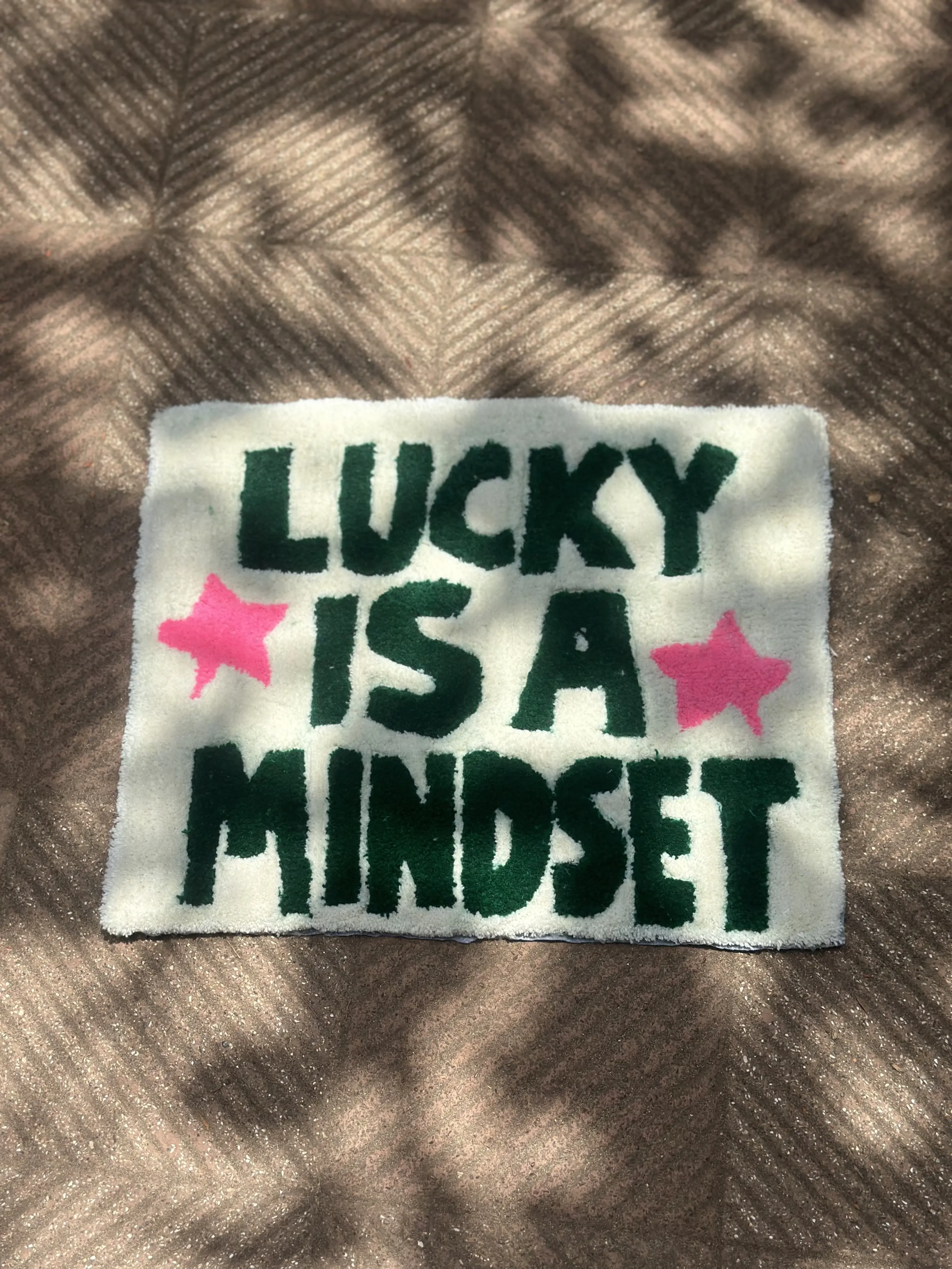 Lucky Mindset green on white tufted rug